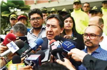  ??  ?? Colombian Attorney-General Nestor Humberto Martinez speaks to the press after the identifica­tion of Ortega, Rivas, and Segarra outside an office of the National Institute of Legal Medicine and Forensic Sciences, in Cali, Colombia. — AFP photo