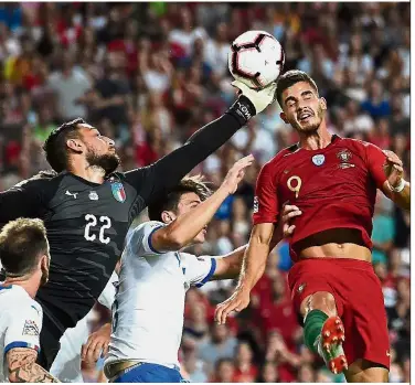  ??  ?? Reaching out: Italy goalkeeper Gianluigi Donnarumma (left) vying with Portugal forward Andre Silva during the UEFA Nations League match at the Luz Stadium in Lisbon on Monday. — AFP