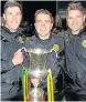  ??  ?? ● Town’s management team Richard Davies, Sean Eardley and Michael Innes with the trophy