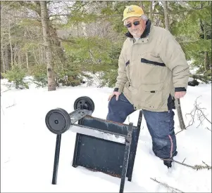  ?? SHARON MONTGOMERY-DUPE/CAPE BRETON POST ?? Stan Wadden, treasurer of the Port Morien Wildlife Associatio­n, looks over a barbecue someone dumped about 20 feet into the woods off Sand Lake Road. Peach says if the heavy garbage pickup isn’t held in the spring, the problem of illegal dumping will...