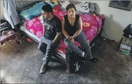  ?? Robert Gauthier Los Angeles Times ?? RUTH PEREZ and her son, Yonathan, inside their decrepit one-bedroom unit at the Chesapeake Apartments in South L.A. “It’s just back-to-back issues,” he said.