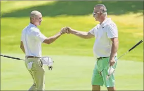  ?? Lori Van Buren / Times Union ?? Daniel Kinn, left, fist bumps with Tom Oppedisano after they finished their round in the Northeaste­rn New York PGA Pro Classic 2 at Pinehaven.
