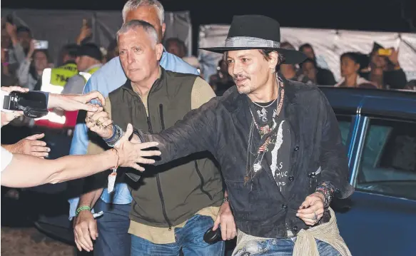  ?? Picture: AP ?? Hollywood star Johnny Depp meets fans upon his arrival at the Glastonbur­y Festival at Worthy Farm, in Somerset, England.