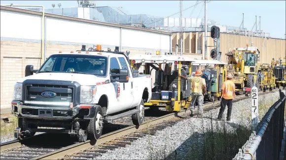  ?? Westside Eagle Observer/MIKE ECKELS ?? A line of work vehicles park near the Decatur Depot waiting to proceed north to inspect and repair any issues in the track caused by the extreme heat in the last few weeks.