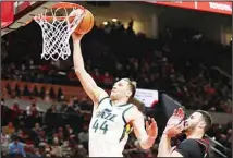  ?? (AP) ?? Utah Jazz forward Bojan Bogdanovic drives to the basket past Portland Trail Blazers forward Larry Nance Jr. during the first half of an NBA basketball game in Portland, Ore,.