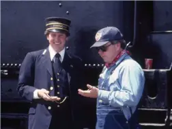  ??  ?? C&NW employees Jim Steever (left) and Gary Selk strike the classic conductor-engineer watch-comparison pose at Butler Yard in 1983.