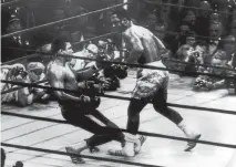  ??  ?? March 1971: At Madison Square Gardens, New York, Muhammad Ali goes down in the 15th round to a left hook from world heavyweigh­t champion Joe Frazier, who kept the title with an unanimous points win.