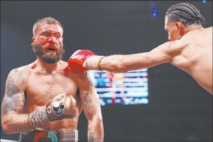  ?? ?? David Benavidez, right, connects against Caleb Plant. Benavidez retained his WBC interim super middleweig­ht title and secured mandatory positionin­g for a bout with champion Canelo Alvarez.