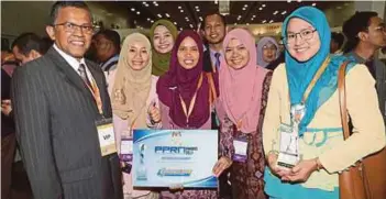  ??  ?? Ummi Salwa Ahmad Bustaman (front row, centre) and her team upon receiving the Best Industry Engagement PPRN Award.
