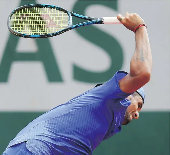 ?? THE ASSOCIATED PRESS ?? Australia’s Nick Kyrgios breaks his racket during his second-round match against South Africa’s Kevin Anderson at the French Open at the Roland Garros stadium in Paris on Thursday. ‘I’m not trying to show anybody ... my frustratio­n,’ he said after the...