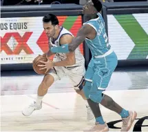  ?? Andy Cross, The Denver Post ?? Nuggets guard Facundo Campazzo gets fouled by Charlotte Hornets guard Terry Rozier in the second quarter at Ball Arena on Wednesday night.