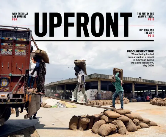  ?? PRABHJOT GILL ?? PROCUREMEN­T TIME Wheat being loaded onto a truck at a mandi in Amritsar during the Covid lockdown, May 2020