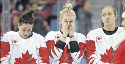  ?? AP PHOTO ?? Canadian women’s hockey players react during the medal ceremony after a 3-2 shootout loss to the U.S. in the goldmedal game.