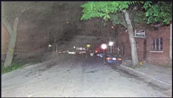  ?? MILWAUKEE POLICE DEPARTMENT ?? Police cars block the end of “The One-Way” in the Garden Homes neighborho­od after the shooting of Eddie Powe in July 2015. Powe told police before he died in a hospital that a man named Tone shot him.