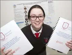  ??  ?? Jennifer Nic Chraith-Ceirin, a 4th year student from Meanscoil Gharman, Enniscorth­y, Wexford, with her project, ‘ An comparad agus imscrudu chun fiosra an befuil Damhsoiri Gaelacha nios aclai no fiu comhionnan le Imreoiri CLC. ‘.