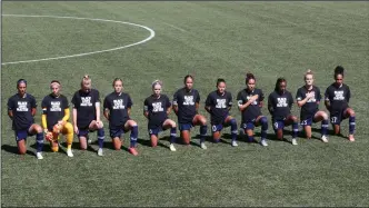  ?? (AP/Rick Bowmer) ?? Players for the North Carolina Courage kneel during the national anthem before the start of their NWSL Challenge Cup match against the Portland Thorns at Zions Bank Stadium on Saturday in Herriman, Utah.