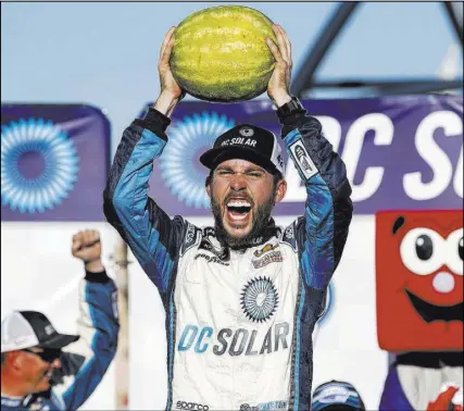  ?? Richard Brian Las Vegas Review-Journal @vegasphoto­graph ?? NASCAR Xfinity Series driver — and Florida watermelon farmer — Ross Chastain celebrates in Victory Lane after winning the DC Solar 300 on Saturday at Las Vegas Motor Speedway.