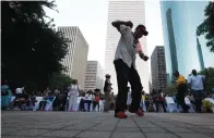  ??  ?? below left
Earnest Jones dances to the music July 1 during the celebratio­n. Photos by Karen Warren/ Houston Chronicle via AP