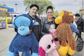  ??  ?? Kevin Durocher and Andrea Pahtayken won enormous plushies from the games at K-Days on Tuesday. They’ve attended the event the past four years.