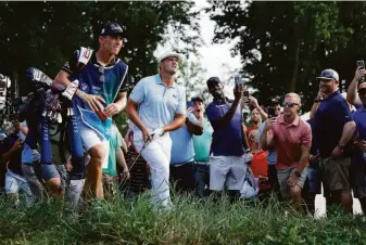  ?? Tim Nwachukwu / Getty Images ?? Bryson DeChambeau, who steadied himself over the final three holes, plays a shot on No. 16 in the third round of the BMW Championsh­ip at Caves Valley Golf Club in Owings Mills, Md.