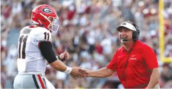  ?? GETTY IMAGES ?? Coach Kirby Smart celebrates with quarterbac­k Jake Fromm during Georgia’s SEC road victory.