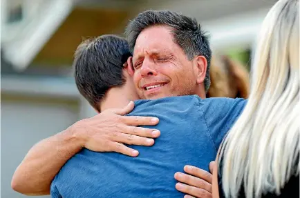  ?? PHOTO: REUTERS ?? Don Damond hugs a neighbour after reading a statement about his fiance, Justine Damond, who was fatally shot by Minneapoli­s police.