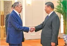  ?? LI XUEREN/XINHUA VIA AP ?? Russian Foreign Minister Sergey Lavrov, left, and Chinese President Xi Jinping meet Tuesday at the Great Hall of the People in Beijing.