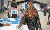  ?? Luis Acosta AFP/Getty Images ?? A WOMAN casts her vote in San Juan Sacatepequ­ez, Guatemala, during the presidenti­al runoff election.