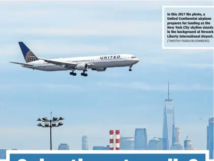  ?? [TIMOTHY FADEK/BLOOMBERG] ?? In this 2017 file photo, a United Continenta­l airplane prepares for landing as the New York City skyline stands in the background at Newark Liberty Internatio­nal Airport.