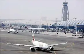  ??  ?? An Emirates airline passenger jet taxis on the tarmac at Dubai internatio­nal airport. Passenger traffic at the airport will exceed 50 million people this year and it is being expanded. – AP