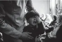  ??  ?? A boy cries on Aug. 30 after his sister was killed in the strike. The Pentagon called it a “tragic mistake” Saturday.