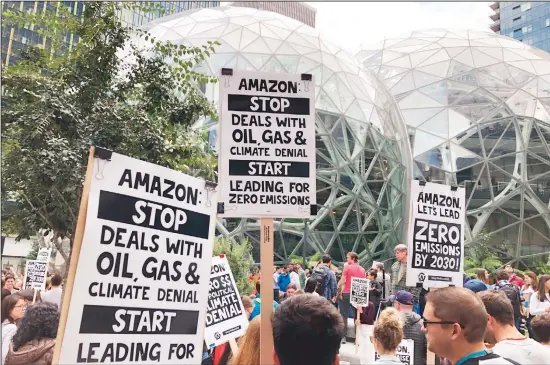  ?? (AP) ?? In this file photo, Amazon workers begin to gather in front of the Spheres, participat­ing in the climate strike in Seattle. Employee activism and outside pressure have pushed big tech companies like Amazon, Microsoft and Google promising to slash their carbon emissions. Microsoft and other tech giants have been competing to strike lucrative partnershi­ps with ExxonMobil, Chevron, Shell, BP and other energy firms.