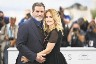  ?? Anne-Christine Poujoulat / AFP via Getty Images 2018 ?? John Travolta and his wife, Kelly Preston, embrace at the Cannes Film Festival in France in 2018. The couple married in 1991 at a midnight ceremony in Paris. They had three children.