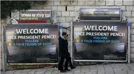  ?? — AFP ?? Men walk past welcoming billboards ahead of the visit of the US vice- president to Israel, on Sunday. US Vice President Mike Pence is on a Middle East tour overshadow­ed by anger in the Arab world over Washington’s recognitio­n of Jerusalem as Israel’s...
