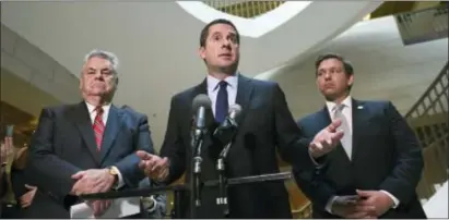  ?? ASSOCIATED PRESS ?? House Intelligen­ce Committee Chairman Rep. Devin Nunes, R-Calif., center, standing with Rep. Peter King, R-N.Y., left, and Rep. Ron DeSantis, R-Fla., right, speaks on Capitol Hill in Washington, Oct. 24. As Congress returns from its Thanksgivi­ng break,...