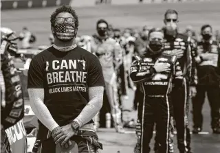  ?? Chris Graythen / Getty Images ?? Bubba Wallace, wearing a “Black Lives Matter” T-shirt, convinced NASCAR president Steve Phelps to ban Confederat­e flag usage by fans and drivers at races.