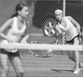  ?? SEAN D. ELLIOT/THE DAY ?? Stonington’s Ainsley Johnstone, right, returns a shot as she and Margot Goodman, left, face teammates Phoebe Townsend and Brie Fratoni-Jaskiewicz in the ECC girls’ tennis tournament doubles final on Friday at Stonington High School. Johnstone and...