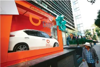  ??  ?? Una persona observa publicidad del servicio de transporte DiDi, en el marco de la presentaci­ón del inicio de operacione­s, en la Ciudad de México, capital de México. La empresa china de servicios de transporte Didi Chuxing operará a partir del 21 de noviembre en la Ciudad de México, en la ampliación más reciente de su penetració­n en Latinoamér­ica. (Xinhua/Francisco Cañedo)