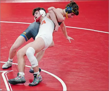  ?? SARAH GORDON/THE DAY ?? Ledyard’s Brayden Grim prepares to take NFA’s Theran Vanase to his back during their 170-pound wrestling match on Wednesday night in Norwich. Grim would later win the match by a medical forfeit as the Colonels outlasted the Wildcats 43-33.