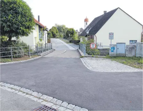  ?? FOTO: BLAUHUT ?? Ein Glück für Rollstuhlf­ahrer: Asphalt und ebene Steinplatt­en ersetzen nun beim Dorfmühlwe­iher die groben Pflasterst­eine. Dort war ein Mann mit seinem Rollstuhl umgekippt und dann auf fremde Hilfe beim Aufrichten angewiesen.