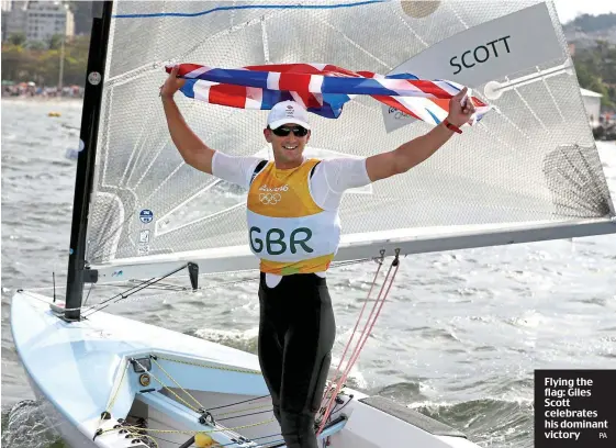  ??  ?? Flying the flag: Giles Scott celebrates his dominant victory