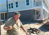  ?? ?? Charles “Chuck” Smith walks outside the new motel he is building.