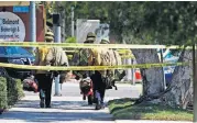  ?? [AP PHOTO] ?? Long Beach firefighte­rs walk along a street on Monday near a retirement home in Long Beach, Calif., where at least one firefighte­r was killed.