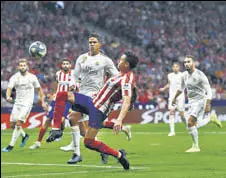  ?? GETTY IMAGES ?? Jose Gimenez of Atletico Madrid battles for the ball with Raphael Varane of Real Madrid in Madrid.