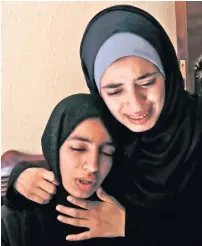  ?? AFP ?? The sisters of Moamen Abu Eyada, 15, mourn during his funeral in Rafah in the southern Gaza Strip on Thursday. —