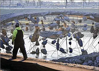  ?? MARSHALL GORBY / STAFF ?? Pieces of concrete hang from reinforcem­ent bars at the demolition site of the old Keowee Street bridge over the Great Miami River in Harrison Twp.