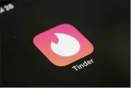  ?? AP PHOTO/PATRICK SISON, FILE ?? FILE - This Tuesday, July 28, 2020, file photo shows the icon for the Tinder dating app on a device in New York. The use of dating apps in the last 18months of the pandemic has surged around the globe. Tinder reported 2020as its busiest year.