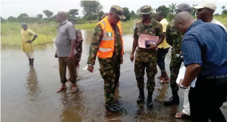  ?? Photo: NAN ?? Director of Search and Rescue, National Emergency Management Agency (NEMA), Air Comdr. Akugbe Iyamu (right) and his team verify a road affected by flood at Ugwoda Community in Idah Local Government of Kogi State yesterday.