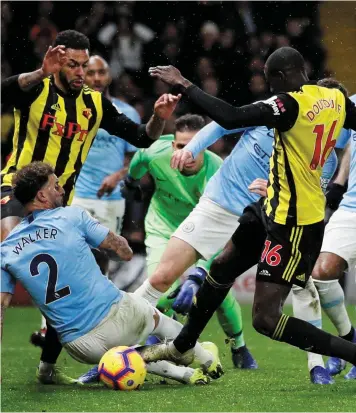  ??  ?? Hornets sting: Watford’s Abdoulaye Doucoure scrambles home a late goal which gave Manchester City a nervy finish