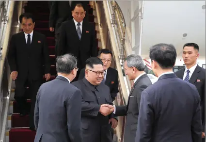  ?? PICTURE: MINISTRY OF COMMUNICAT­IONS AND INFORMATIO­N, SINGAPORE/AP ?? In this photo released by the Ministry of Communicat­ions and Informatio­n of Singapore, North Korean leader Kim Jong-un, centre, is greeted by Singapore Minister for Foreign Affairs Dr Vivian Balakrishn­an at Changi Internatio­nal Airport yesterday in...